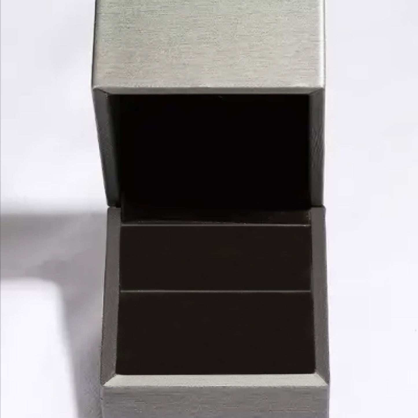 Empty jewelry box with a black interior suitable for 925 sterling silver items.